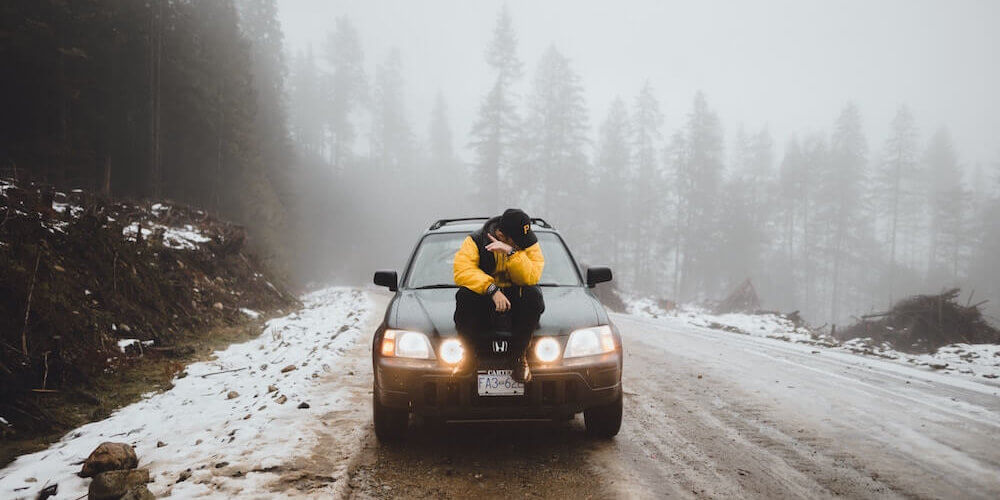 image of man sat on car