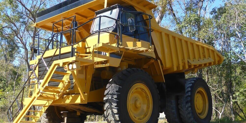 large yellow truck in woods