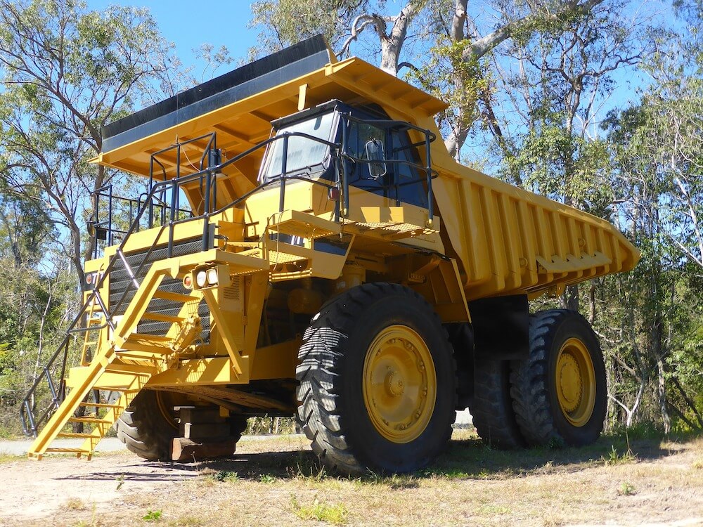 large yellow truck in woods