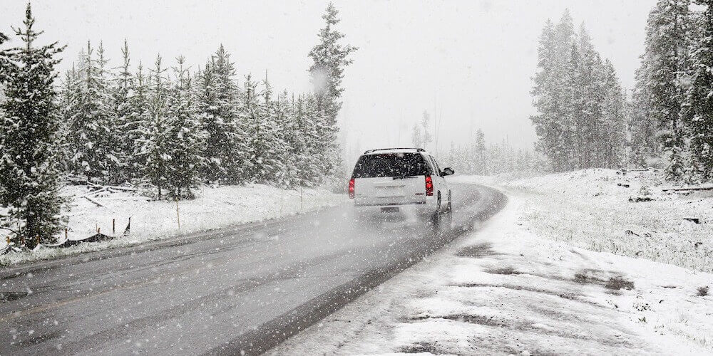 car in white snowy landscape