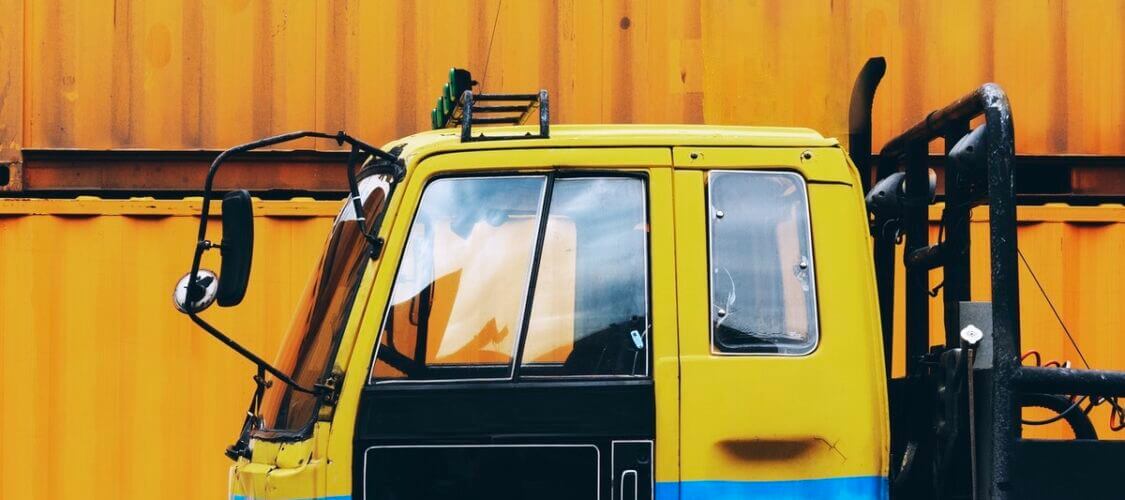 vibrant image of hgv truck in yellow and blue