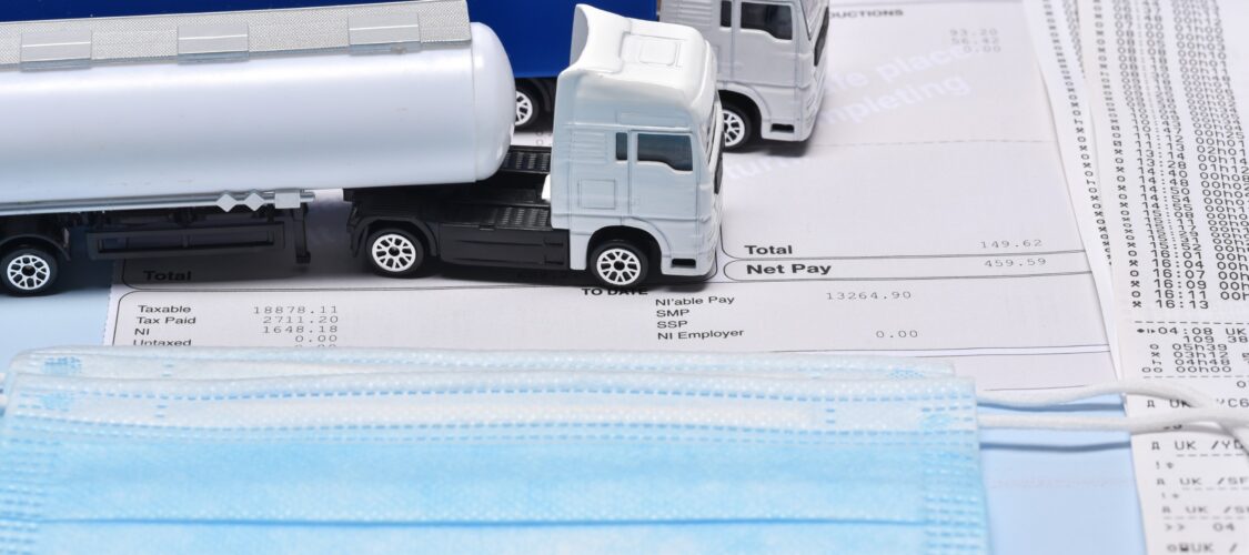 pay slip with toy lorries and a face mask