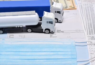 pay slip with toy lorries and a face mask