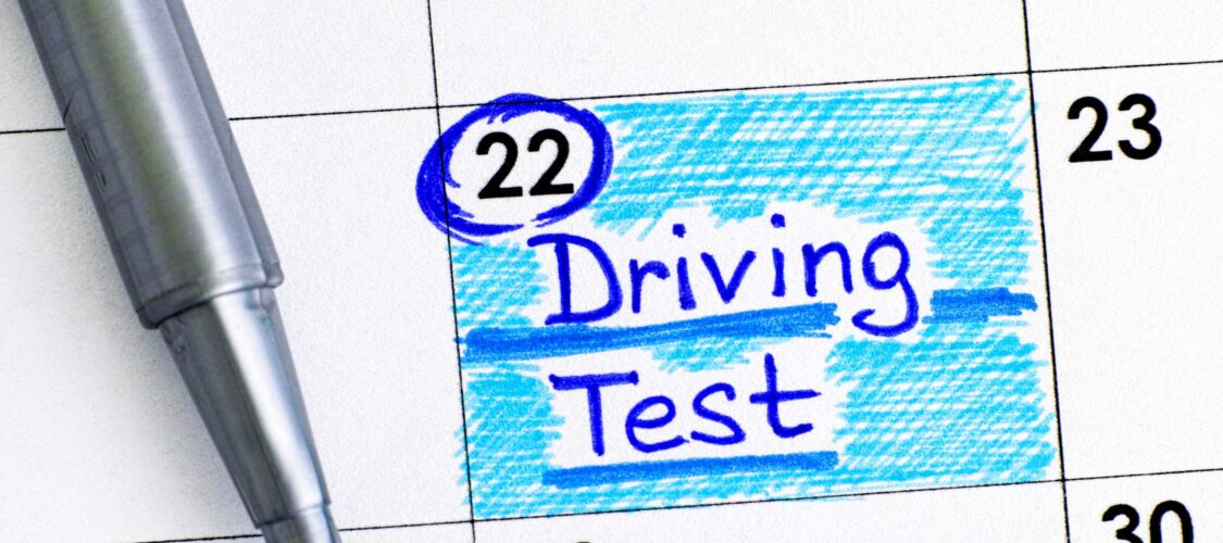 calendar with a pen. driving test date has been marked on the 22nd of the month.