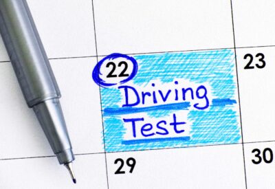 calendar with a pen. driving test date has been marked on the 22nd of the month.